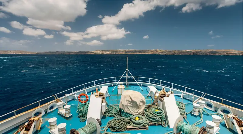 Boat crossing the open sea between Malta, Comino and Gozo on a full-day island-hopping cruise